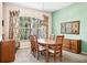 Traditional dining room featuring wood furniture and a large window with natural light at 2221 Platinum Dr, Sun City Center, FL 33573