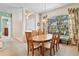 Charming dining room with a wood table, large windows, and a cozy atmosphere at 2221 Platinum Dr, Sun City Center, FL 33573