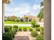 Inviting home exterior featuring lush landscaping, a paver walkway, and a well-maintained lawn, creating a serene ambiance at 2221 Platinum Dr, Sun City Center, FL 33573