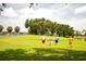 Scenic golf course view featuring lush green fairways, mature trees, and golfers enjoying a round on a sunny day at 2221 Platinum Dr, Sun City Center, FL 33573