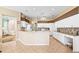 Bright kitchen with granite countertops, white cabinetry and an open floor plan at 2221 Platinum Dr, Sun City Center, FL 33573