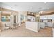 Open floor plan showing dining room and kitchen with granite countertops and bar seating at 2221 Platinum Dr, Sun City Center, FL 33573