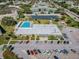 Aerial view showing a large pool, solar panels, and ample parking at the community center at 2310 Denmark St # 34, Clearwater, FL 33763