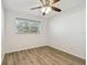 Bedroom featuring wood-look floors and a large window at 2310 Denmark St # 34, Clearwater, FL 33763