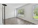 A bedroom with wood grain flooring, sliding closet doors and a large window at 2310 Denmark St # 34, Clearwater, FL 33763