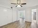 Bright bedroom featuring a ceiling fan, closet, and en-suite bath at 2310 Denmark St # 34, Clearwater, FL 33763