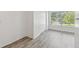 A bedroom with a large window allowing natural light to illuminate the wood grain flooring at 2310 Denmark St # 34, Clearwater, FL 33763