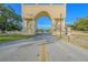 Grand entrance to community featuring an ornate archway and manicured landscaping at 2310 Denmark St # 34, Clearwater, FL 33763
