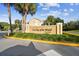 Attractive community sign 'On Top of the World Paradise' with lush landscaping and palm trees at 2310 Denmark St # 34, Clearwater, FL 33763