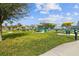 Grilling area features picnic tables and yellow sunshades for comfortable outdoor gatherings at 2310 Denmark St # 34, Clearwater, FL 33763