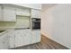 A kitchen featuring white cabinets, a sink, stove top, and a built-in oven at 2310 Denmark St # 34, Clearwater, FL 33763