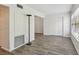 A living room with wood grain flooring, sliding closet doors and a large window at 2310 Denmark St # 34, Clearwater, FL 33763