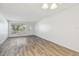 Inviting living room featuring neutral walls and gray-tone flooring, complemented by a sunlit window at 2310 Denmark St # 34, Clearwater, FL 33763