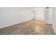 Minimalist living room featuring gray-tone flooring, neutral walls, and a chandelier that offers brightness at 2310 Denmark St # 34, Clearwater, FL 33763