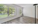A living room with wood grain flooring and a large window to provide natural light at 2310 Denmark St # 34, Clearwater, FL 33763