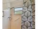 Tile shower with grab bar, window, and shower head at 2310 Denmark St # 34, Clearwater, FL 33763