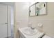 Bathroom featuring a sink, a tile backsplash, and a mirrored medicine cabinet at 2311 Brisbane St # 45, Clearwater, FL 33763