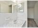 Bathroom sink with a white countertop, tile backsplash, and a mirror at 2311 Brisbane St # 45, Clearwater, FL 33763