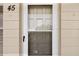 Close-up of unit #45 entrance with screened door and stone facade at 2311 Brisbane St # 45, Clearwater, FL 33763