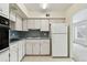 The kitchen features white cabinets, updated appliances, and plenty of natural light at 2311 Brisbane St # 45, Clearwater, FL 33763