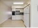 Open kitchen with tiled floor and white appliances at 2311 Brisbane St # 45, Clearwater, FL 33763