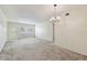Open living area with ample space, large window, and chandelier at 2311 Brisbane St # 45, Clearwater, FL 33763