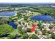 An aerial view of the home showcases its prime location on a tree-lined street near multiple lakes at 2454 Shadecrest Rd, Land O Lakes, FL 34639