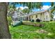 Backyard features a spacious screened-in patio, lush green lawn, swing set, and slide at 2454 Shadecrest Rd, Land O Lakes, FL 34639