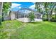 Large screened-in patio in a level backyard with well-maintained lawn and privacy at 2454 Shadecrest Rd, Land O Lakes, FL 34639