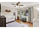Cozy bedroom with wood floors, ceiling fan, window and crib at 2454 Shadecrest Rd, Land O Lakes, FL 34639