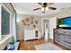 Bedroom with a television, window with curtains and wood floor at 2454 Shadecrest Rd, Land O Lakes, FL 34639