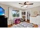 Bedroom with a television, window with curtains and wood floor at 2454 Shadecrest Rd, Land O Lakes, FL 34639