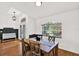Dining room featuring hardwood floors, a wooden table, and a large window at 2454 Shadecrest Rd, Land O Lakes, FL 34639