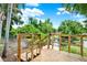 New wooden dock overlooking lush, green waterfront with blue sky, perfect for relaxing and enjoying nature at 2454 Shadecrest Rd, Land O Lakes, FL 34639