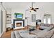 Living room featuring a fireplace, hardwood floors, comfortable seating, and a ceiling fan at 2454 Shadecrest Rd, Land O Lakes, FL 34639