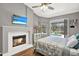Main bedroom featuring a fireplace, ceiling fan, and a view of the backyard pool at 2454 Shadecrest Rd, Land O Lakes, FL 34639
