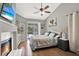 Main bedroom featuring a fireplace, ceiling fan, and a view of the backyard pool at 2454 Shadecrest Rd, Land O Lakes, FL 34639