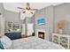 This main bedroom has a fireplace, ceiling fan, television and decor at 2454 Shadecrest Rd, Land O Lakes, FL 34639