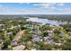 Panoramic aerial view of homes with pools nestled among trees near a lake at 2819 Safe Harbor Dr, Tampa, FL 33618