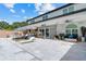 Expansive backyard with a luxurious pool, lounge chairs, outdoor kitchen, and shaded seating areas for entertaining at 2819 Safe Harbor Dr, Tampa, FL 33618