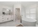 Elegant bathroom boasts marble floors, a free standing tub, and double vanity at 2819 Safe Harbor Dr, Tampa, FL 33618