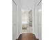 Hallway view into the main bathroom featuring a soaking tub and frameless shower at 2819 Safe Harbor Dr, Tampa, FL 33618