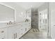 Bright bathroom with marble counters and floors, and a frameless shower at 2819 Safe Harbor Dr, Tampa, FL 33618