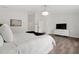 Bright bedroom with wood floors features a tufted headboard and simple modern furniture at 2819 Safe Harbor Dr, Tampa, FL 33618