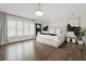 Bright bedroom with wood floors features a tufted headboard and plantation shutters at 2819 Safe Harbor Dr, Tampa, FL 33618