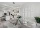Dining room with clear glass table and white chairs, adjacent to a bright, modern kitchen at 2819 Safe Harbor Dr, Tampa, FL 33618