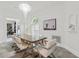 Bright dining room with a glass table, marble floors, chandelier, and neutral paint at 2819 Safe Harbor Dr, Tampa, FL 33618