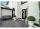 Charming front entrance with a decorative wreath, brick patio, and stylish outdoor seating at 2819 Safe Harbor Dr, Tampa, FL 33618