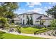 Elegant two-story home with meticulously manicured lawn, decorative shrubs, and a circular driveway at 2819 Safe Harbor Dr, Tampa, FL 33618