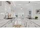 Beautiful kitchen featuring white cabinets, marble countertops, and stainless steel appliances, open to a dining area at 2819 Safe Harbor Dr, Tampa, FL 33618